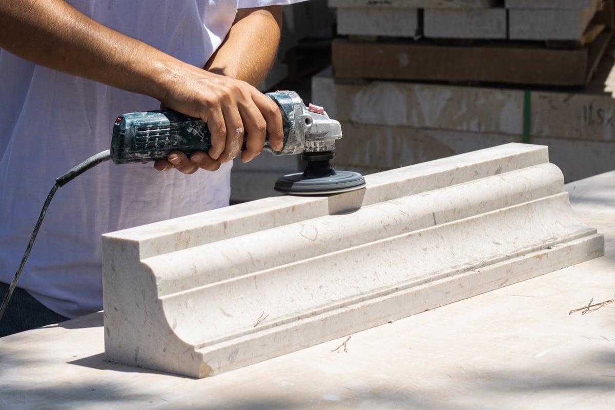 Technician honing and grinding a marble surface