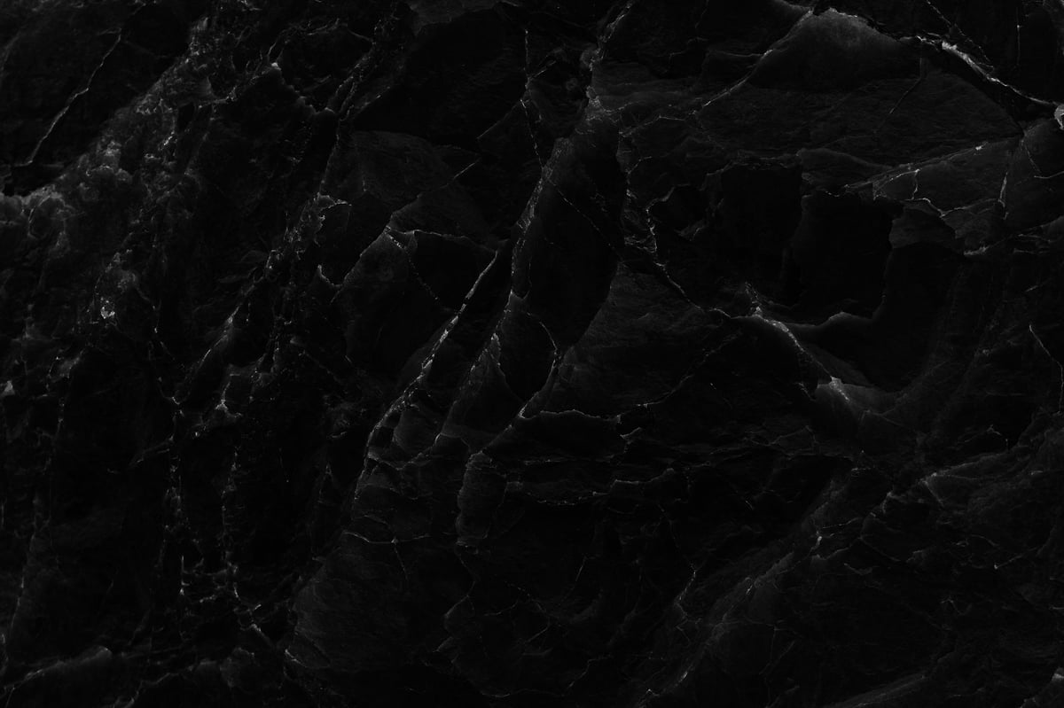 Close-up of a damaged marble surface showing cracks and scratches