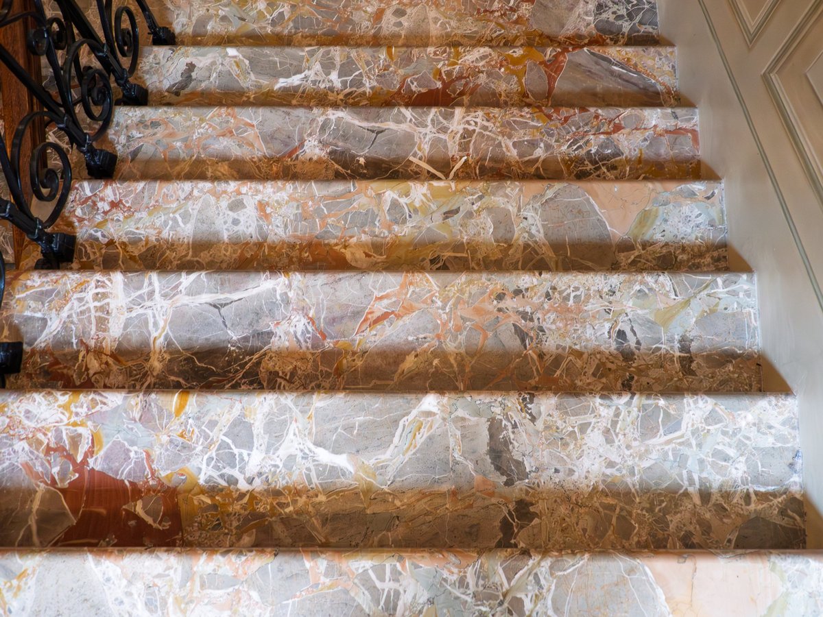 Elegant marble staircase with intricate patterns in a refined classic New England home
